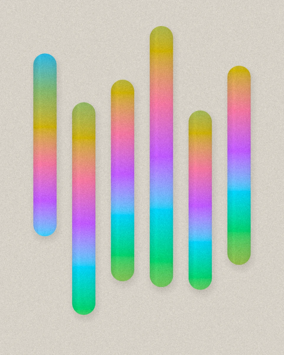 Six tall pills of different lengths, each walking from blue through pink, gold and green, casting soft shadows.